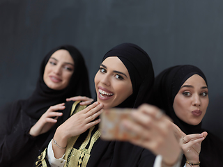 Image showing Portrait of Arab women wearing traditional clothes or abaya taking selfie