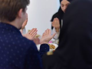 Image showing Muslim family making iftar dua to break fasting during Ramadan