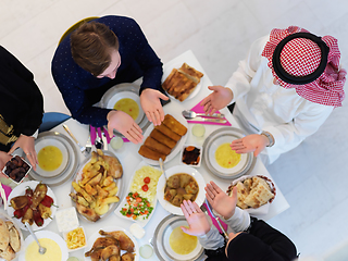 Image showing Top view of Muslim family making iftar dua to break fasting during Ramadan