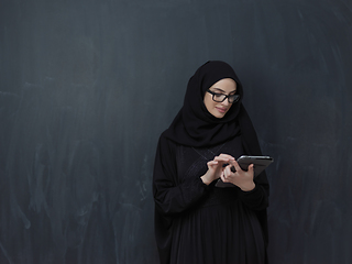 Image showing Young Arab businesswoman in traditional clothes or abaya with tablet computer