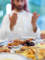 Image showing Muslim man making iftar dua to break fasting during Ramadan