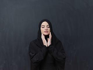 Image showing Portrait of young Muslim woman making dua