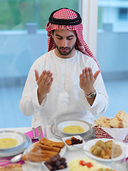 Image showing Muslim man making iftar dua to break fasting during Ramadan