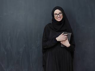 Image showing Young Arab businesswoman in traditional clothes or abaya with tablet computer