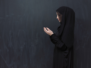 Image showing Portrait of young Muslim woman making dua