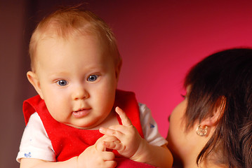 Image showing A girl with her mammy holding her