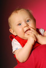 Image showing A thoughtful little girl playing with fingers