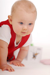 Image showing A child sitting on a floor