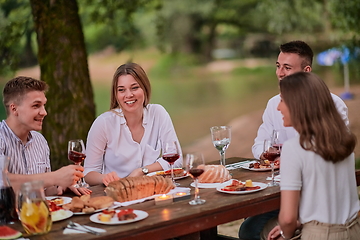 Image showing friends having picnic french dinner party outdoor during summer holiday