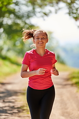 Image showing woman enjoying in a healthy lifestyle while jogging