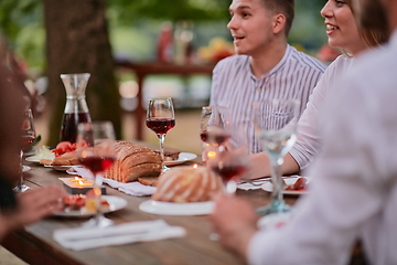 Image showing friends having picnic french dinner party outdoor during summer holiday