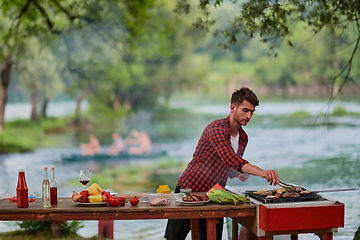 Image showing man cooking tasty food for french dinner party