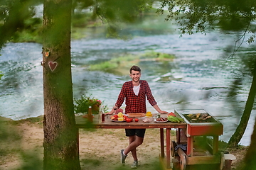 Image showing man cooking tasty food for french dinner party