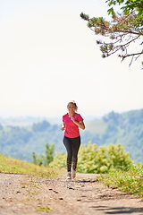 Image showing woman enjoying in a healthy lifestyle while jogging