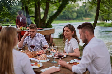 Image showing friends having picnic french dinner party outdoor during summer holiday