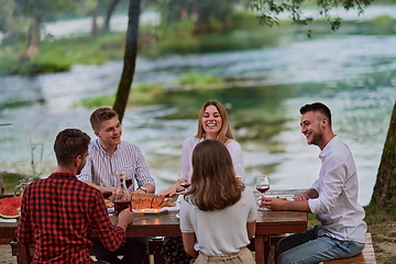 Image showing friends having picnic french dinner party outdoor during summer holiday