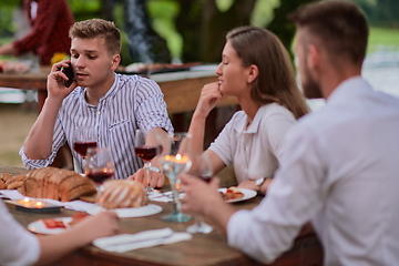 Image showing friends having picnic french dinner party outdoor during summer holiday