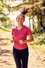 Image showing woman enjoying in a healthy lifestyle while jogging