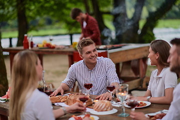 Image showing friends having picnic french dinner party outdoor during summer holiday