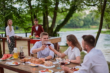 Image showing friends having picnic french dinner party outdoor during summer holiday