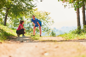 Image showing couple enjoying in a healthy lifestyle while jogging on a country road