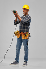 Image showing happy indian builder in helmet with electric drill