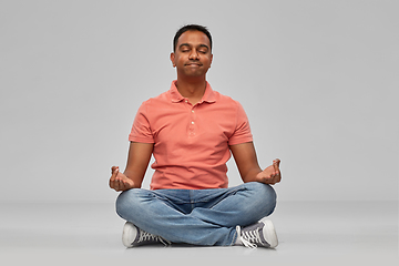 Image showing happy indian mant meditating in lotus yoga pose