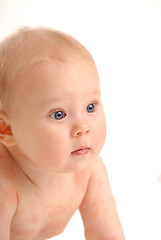 Image showing A naked baby looking around