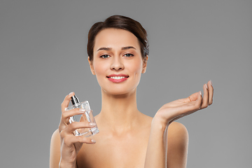 Image showing happy woman with perfume