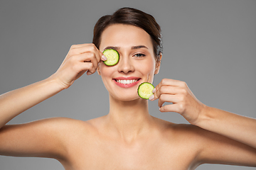 Image showing beautiful woman making eye mask of cucumbers