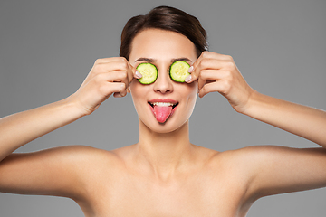 Image showing beautiful woman making eye mask of cucumbers