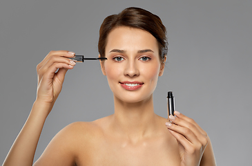 Image showing beautiful woman applying mascara