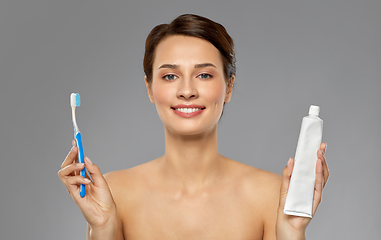 Image showing smiling woman with toothbrush cleaning teeth