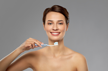 Image showing smiling woman with toothbrush cleaning teeth