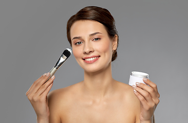 Image showing beautiful young woman with facial mask and brush