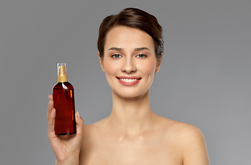 Image showing beautiful young woman with sun protective oil