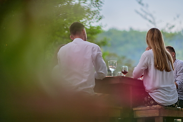 Image showing friends having picnic french dinner party outdoor during summer holiday