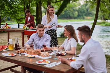 Image showing friends having picnic french dinner party outdoor during summer holiday