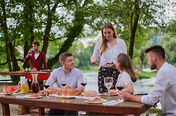 Image showing friends having picnic french dinner party outdoor during summer holiday