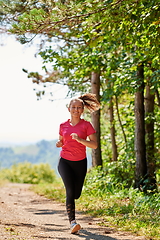 Image showing woman enjoying in a healthy lifestyle while jogging