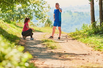 Image showing couple enjoying in a healthy lifestyle while jogging on a country road