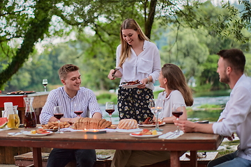 Image showing friends having picnic french dinner party outdoor during summer holiday