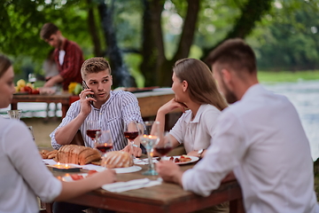 Image showing friends having picnic french dinner party outdoor during summer holiday