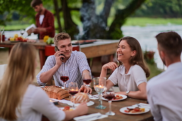 Image showing friends having picnic french dinner party outdoor during summer holiday