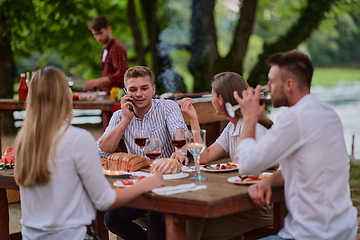 Image showing friends having picnic french dinner party outdoor during summer holiday