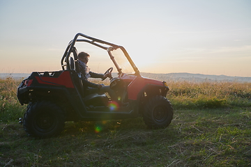 Image showing man enjoying beautiful sunny day while driving a off road buggy car