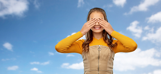 Image showing smiling teenage girl closing her eyes over sky