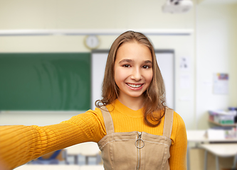 Image showing happy student girl taking selfie at school