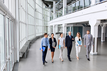 Image showing business people walking along office building