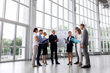 Image showing business team with scheme on flip chart at office